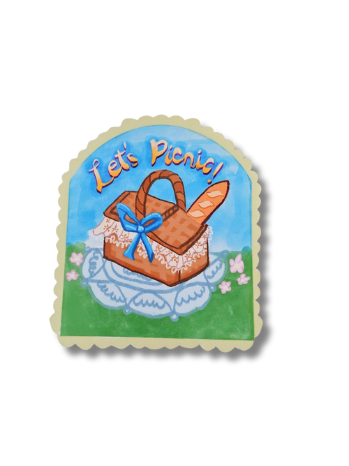 Decorative sticker with a picnic basket and 'Let's Picnic!' text on a white background