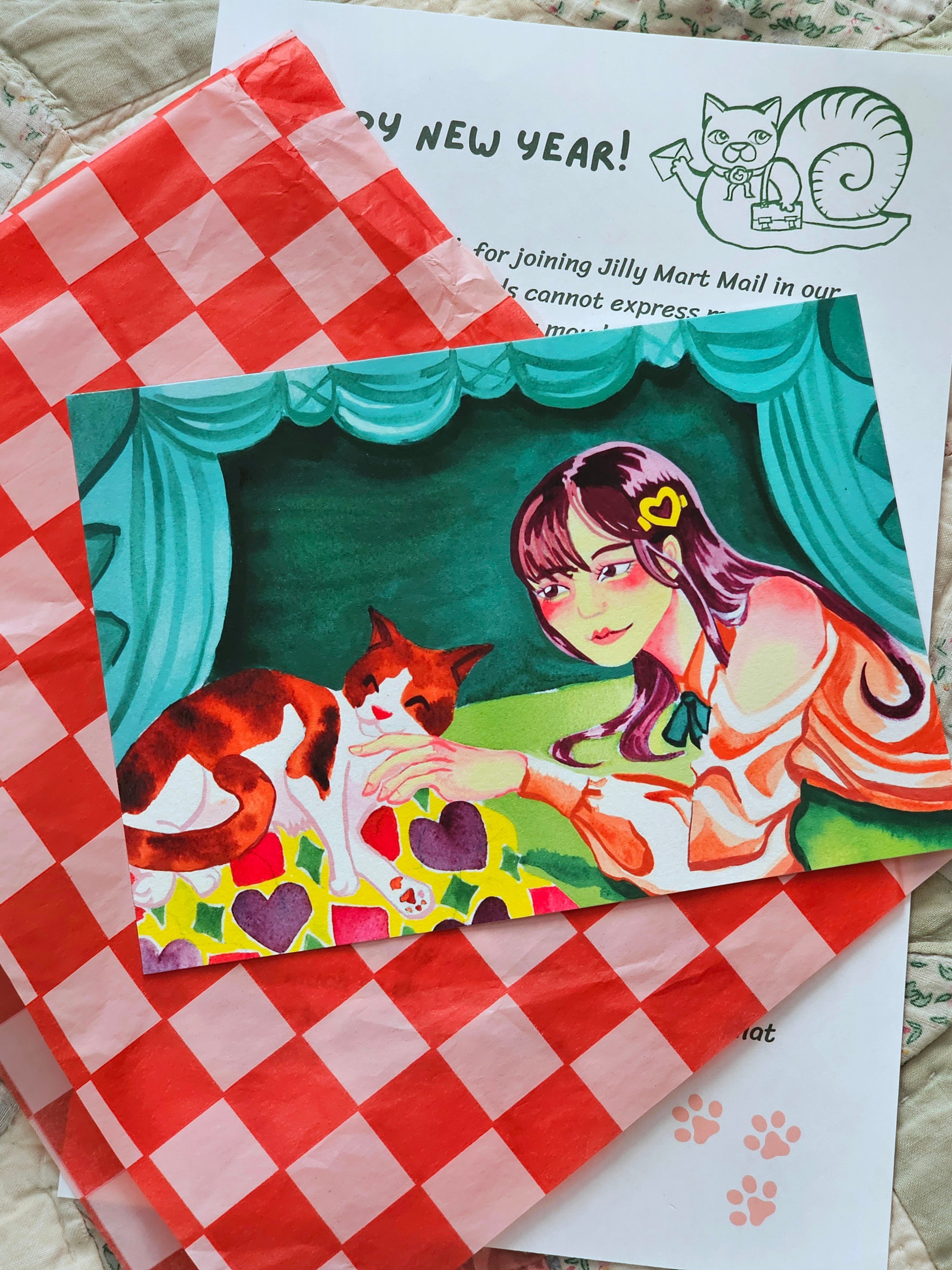 Vintage-style post card print with a woman and cat on a checkered tissue paper and a typed letter.