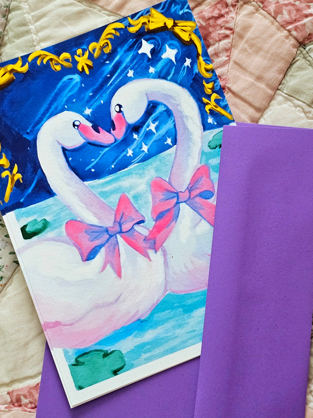 Postcard with a swan design on a purple envelope.